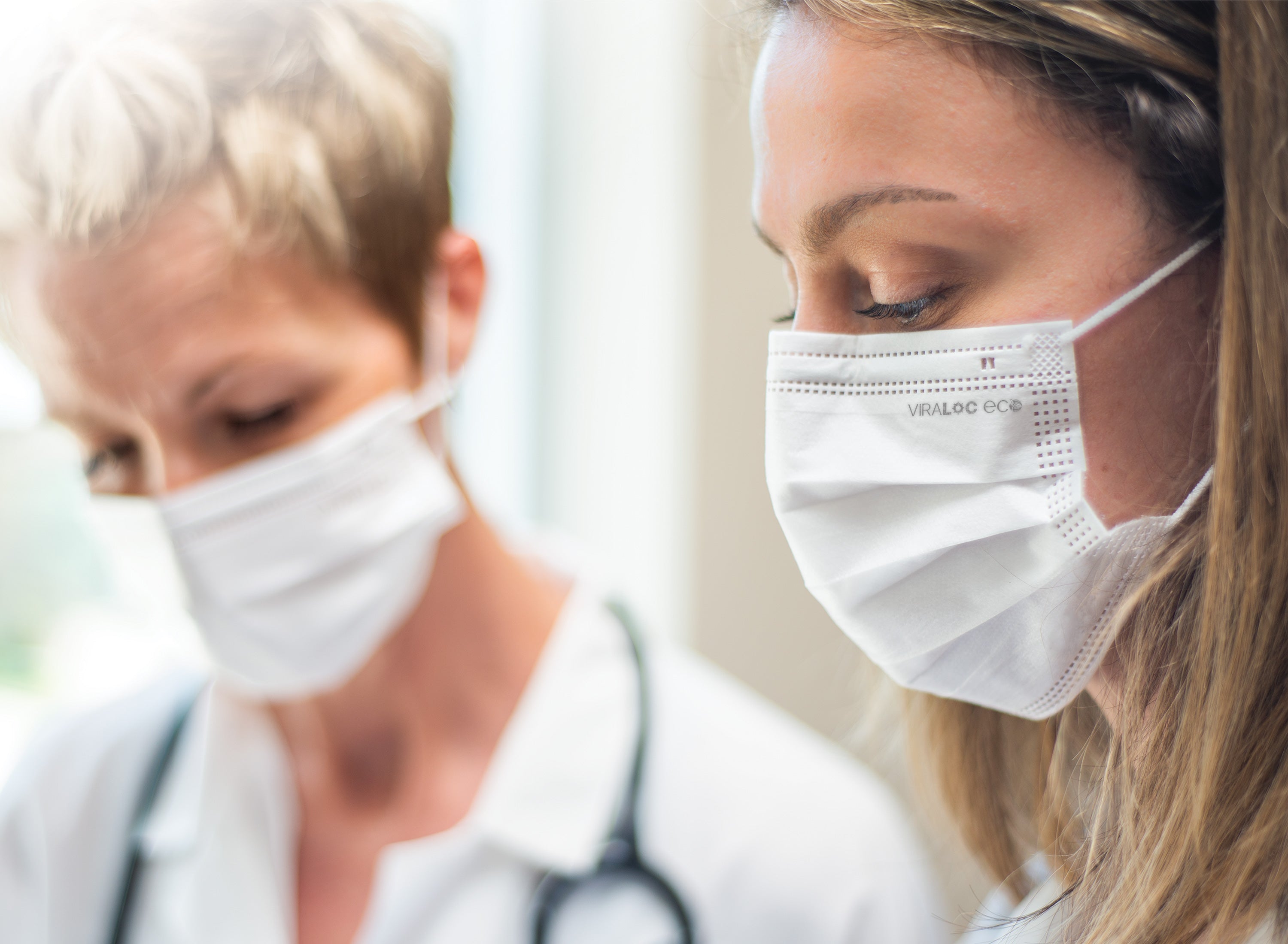 Female healthcare workers nurse and doctor wearing white compostable biodegradable canadian masks Viraloc Eco from Canada Strong