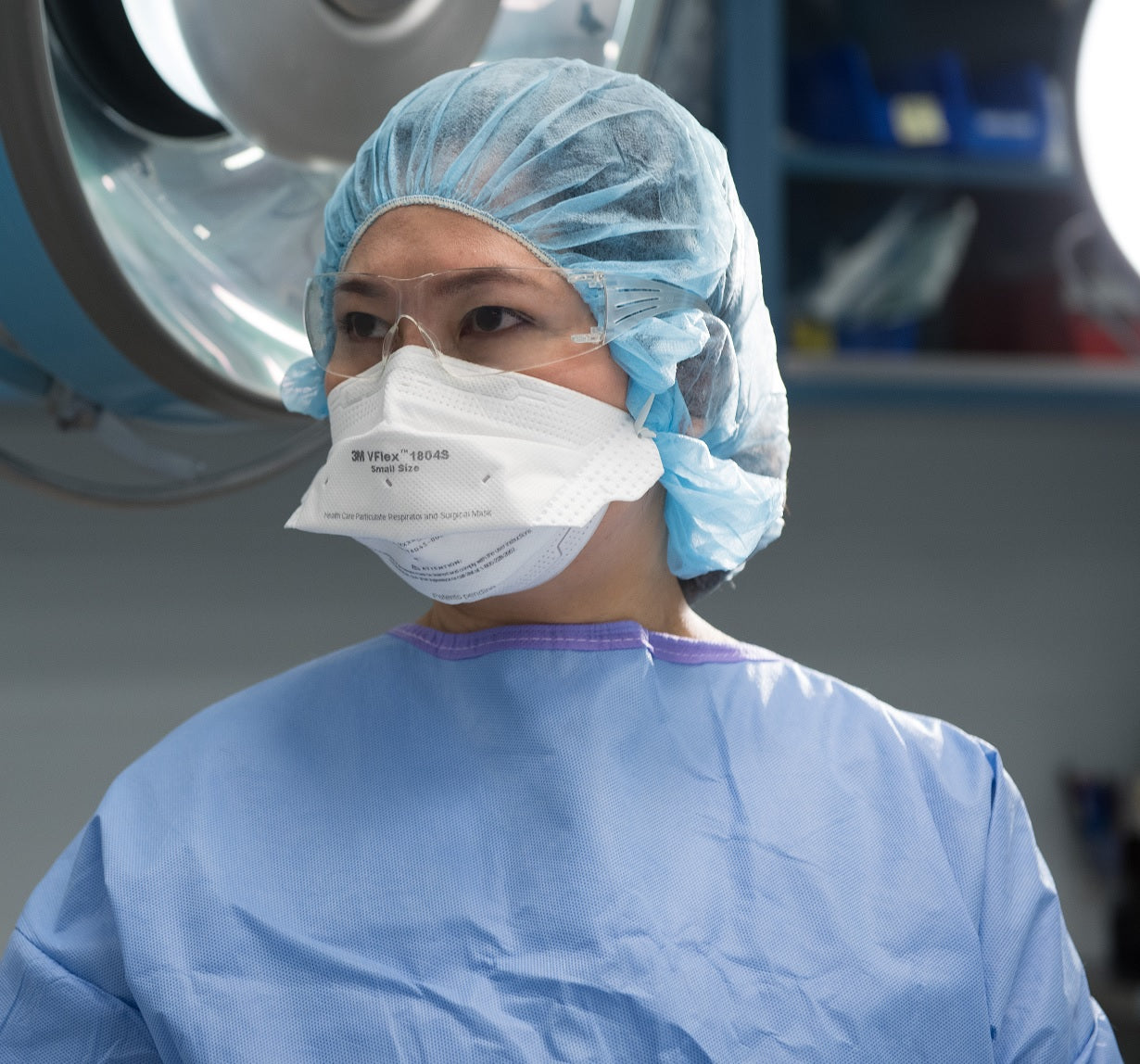 healthcare woman wearing 3M Canada 1804 surgical respirator mask N95 in hospital operating room